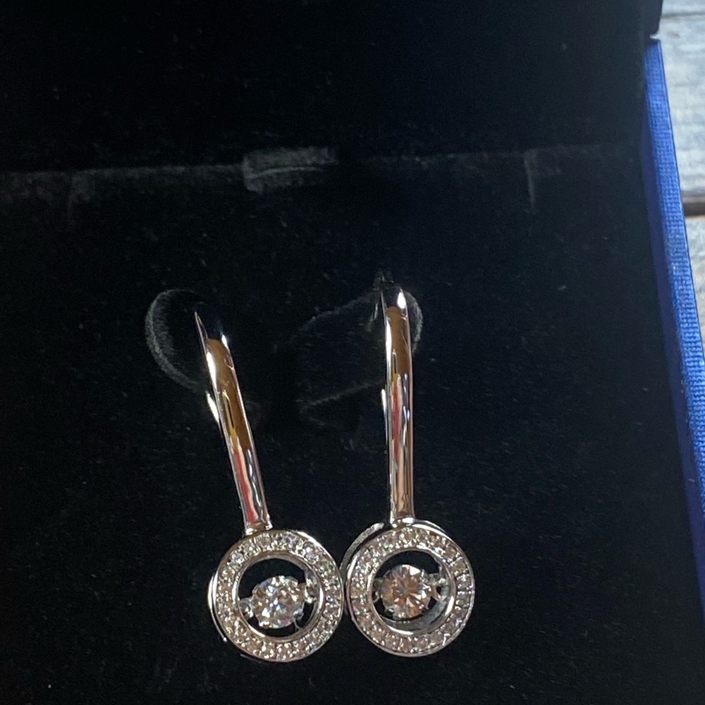 New~Stunning sterling silver dancing “diamond” drop earrings. Never worn